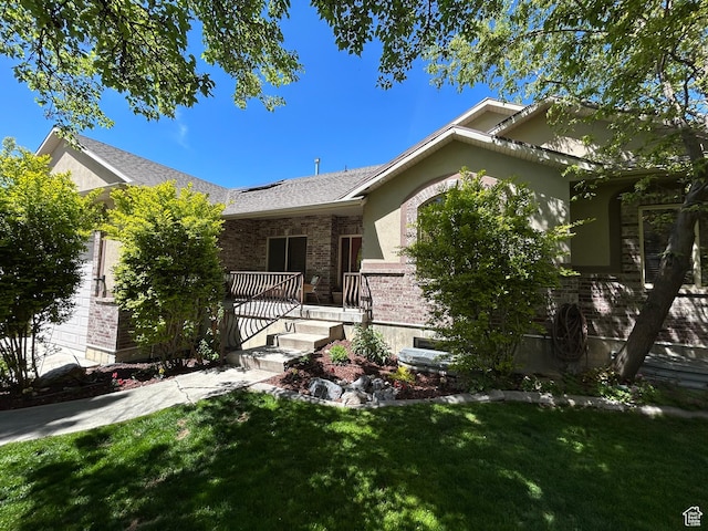 9575 Aztec Dr, Cedar Hills, UT 84062 - view of front of property with stucco siding, a front lawn, and brick siding
