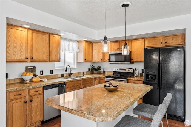 2419 N Nectar Way, Saratoga Springs, UT 84045 - kitchen with stainless steel appliances, a sink, a breakfast bar, hanging light fixtures, and a center island