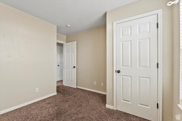 2419 N Nectar Way, Saratoga Springs, UT 84045 - unfurnished bedroom featuring dark carpet, baseboards, and a textured ceiling
