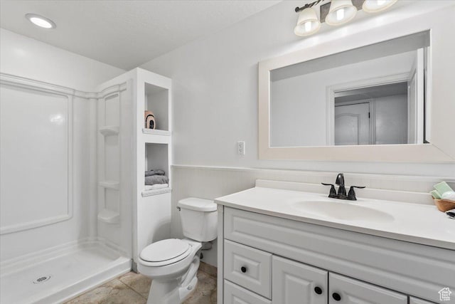 2419 N Nectar Way, Saratoga Springs, UT 84045 - full bathroom with a shower stall, vanity, toilet, and a wainscoted wall