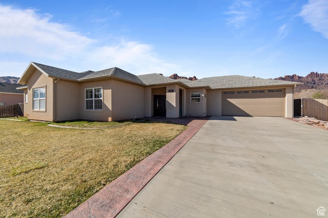 4224 Valle Del Sol, Moab, UT 84532 - single story home with an attached garage, fence, concrete driveway, stucco siding, and a front yard