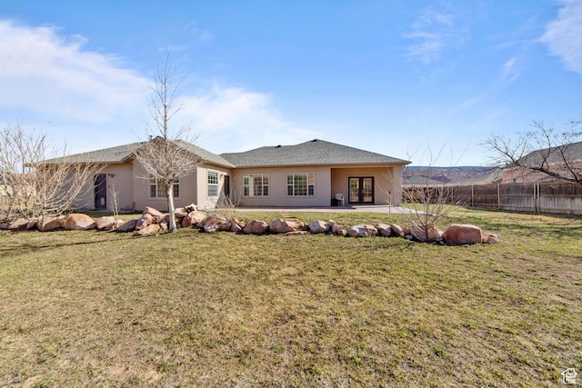 4224 Valle Del Sol, Moab, UT 84532 - back of house with a patio, fence, a lawn, and french doors