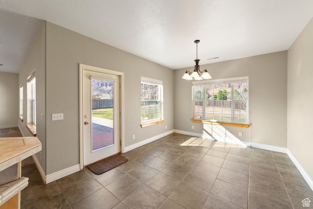 4224 Valle Del Sol, Moab, UT 84532 - unfurnished dining area with visible vents, baseboards, a notable chandelier, and dark tile patterned flooring