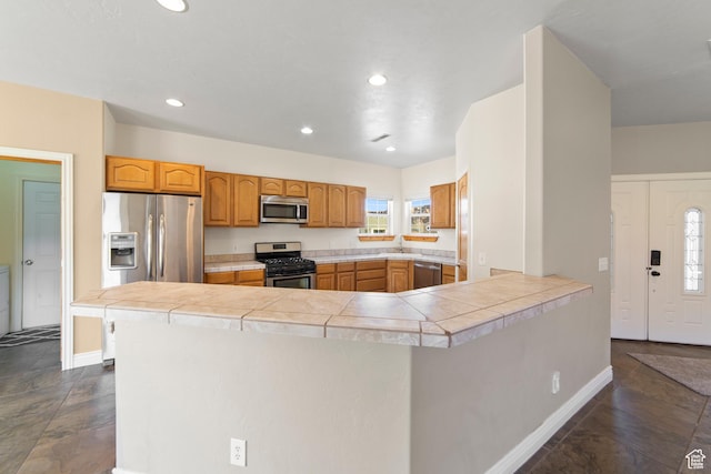 4224 Valle Del Sol, Moab, UT 84532 - kitchen with recessed lighting, a peninsula, a sink, light countertops, and appliances with stainless steel finishes