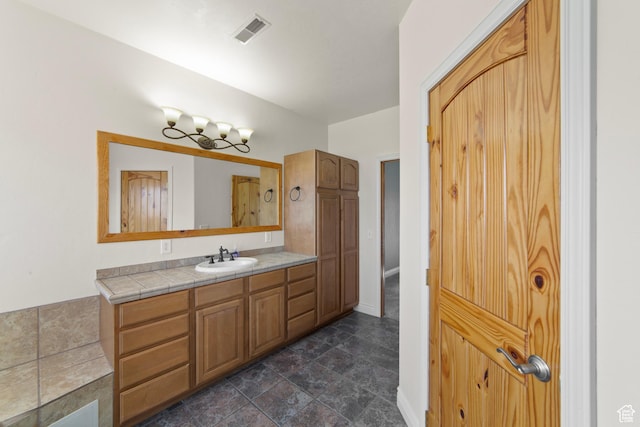 4224 Valle Del Sol, Moab, UT 84532 - bathroom with baseboards, visible vents, stone finish flooring, and vanity