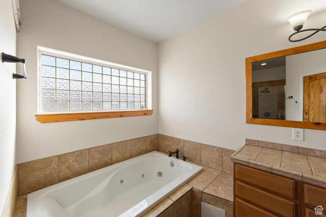 4224 Valle Del Sol, Moab, UT 84532 - full bath with tiled shower, a jetted tub, and vanity