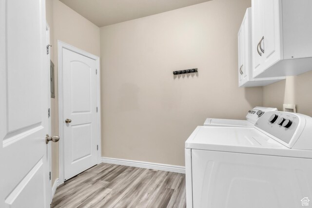 1351 Westbridge Cir, Provo, UT 84601 - laundry area featuring cabinet space, separate washer and dryer, light wood-style floors, and baseboards
