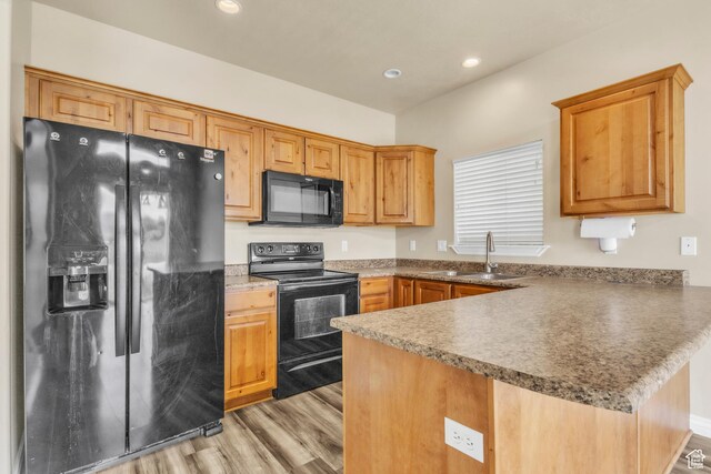 1351 Westbridge Cir, Provo, UT 84601 - kitchen with black appliances, a sink, a peninsula, light wood-style flooring, and recessed lighting