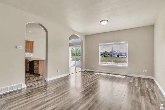 1351 Westbridge Cir, Provo, UT 84601 - unfurnished room featuring arched walkways, wood finished floors, and baseboards