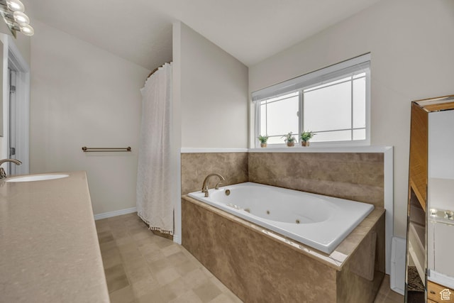 bathroom with a jetted tub and vanity