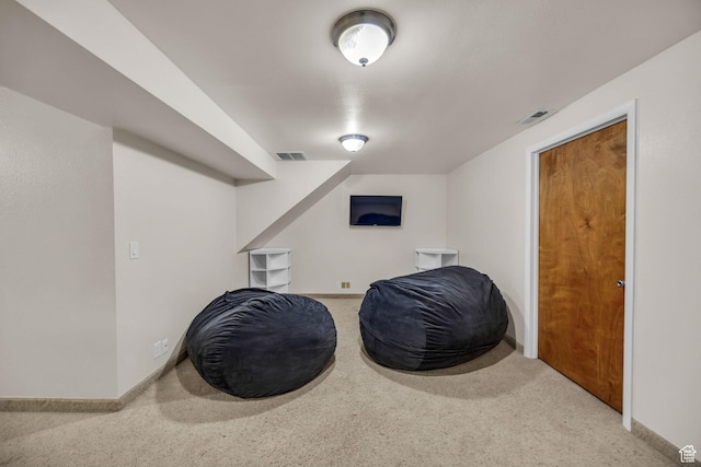 sitting room with visible vents, baseboards, and carpet floors