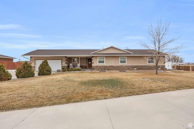 ranch-style home with stone siding, an attached garage, a front yard, and fence