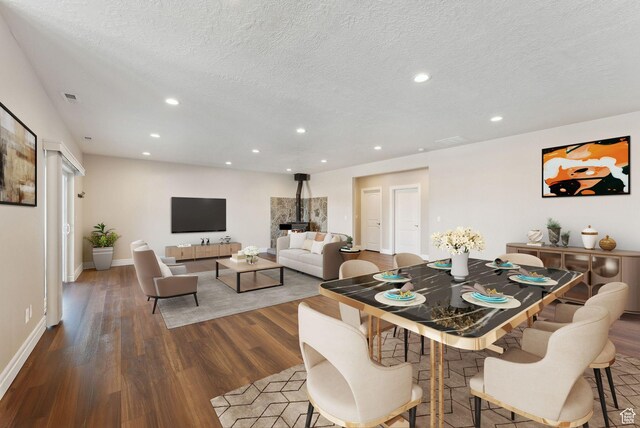 11680 E 29130 N, Fairview, UT 84629 - dining space featuring wood finished floors, a textured ceiling, recessed lighting, baseboards, and a wood stove