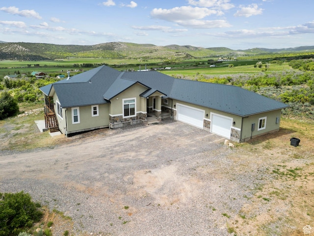 11680 E 29130 N, Fairview, UT 84629 - view of front of house with stucco siding, a mountain view, stone siding, and a garage