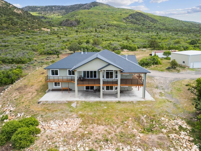 11680 E 29130 N, Fairview, UT 84629 - rear view of house with a patio area, a deck with mountain view, and a wooded view