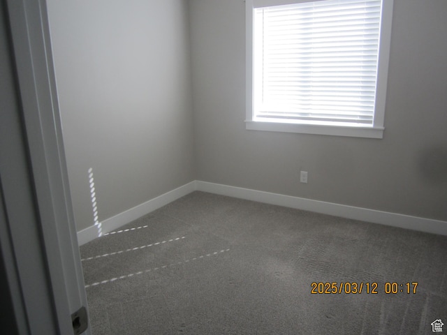 spare room with carpet and baseboards