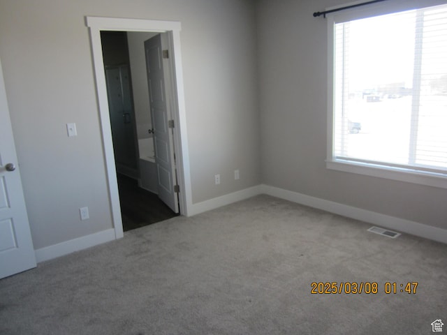 unfurnished bedroom featuring visible vents, baseboards, and carpet