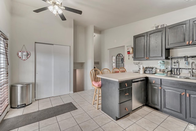 3734 S Bannock St, West Valley City, UT 84120 - kitchen featuring dishwasher, a peninsula, light countertops, a sink, and light tile patterned flooring