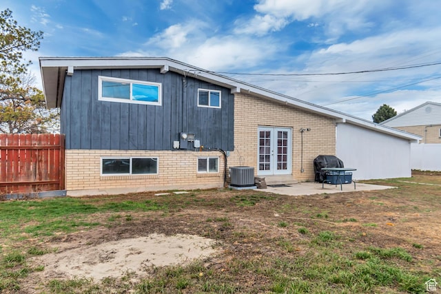 3734 S Bannock St, West Valley City, UT 84120 - rear view of property with a patio, central AC, brick siding, fence, and french doors