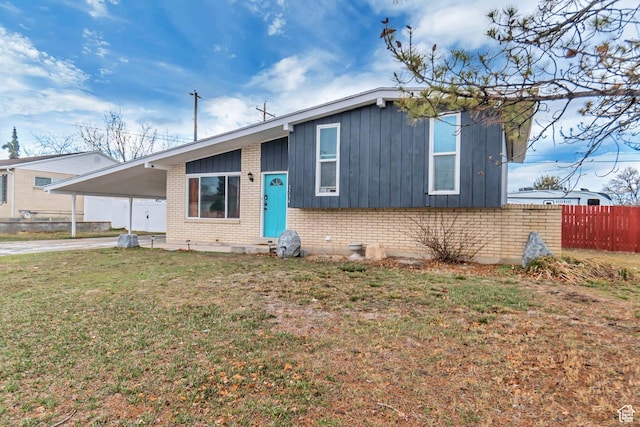 3734 S Bannock St, West Valley City, UT 84120 - view of front of property with brick siding, concrete driveway, a front yard, fence, and an attached carport