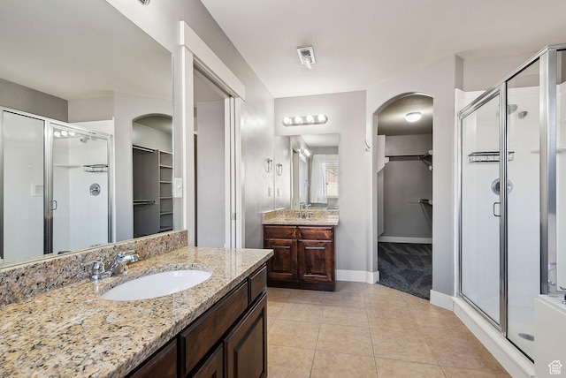 2887 N 1175 W, Layton, UT 84041 - bathroom featuring a stall shower, two vanities, a sink, and tile patterned floors
