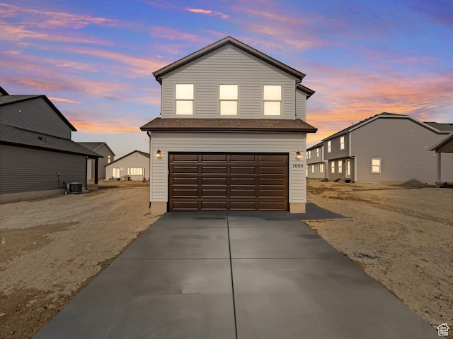 1604 E Pheasant Rd Unit 208, Eagle Mountain, UT 84005 - traditional-style house featuring central AC unit, concrete driveway, and an attached garage
