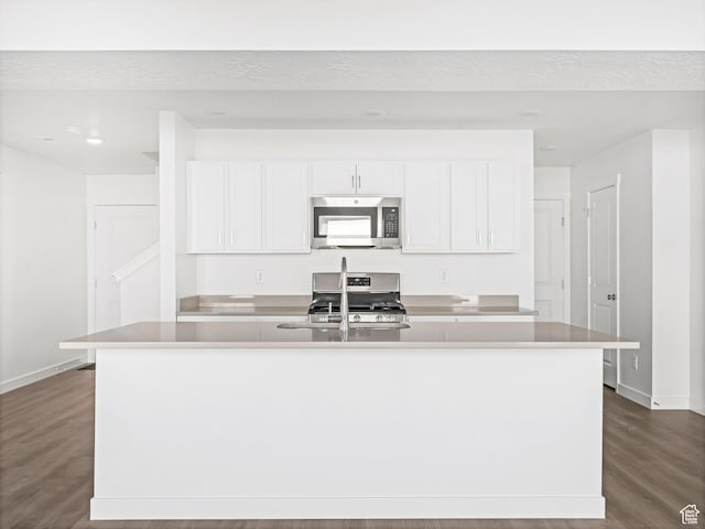 1604 E Pheasant Rd Unit 208, Eagle Mountain, UT 84005 - kitchen featuring stainless steel appliances, dark wood-style floors, an island with sink, and white cabinets
