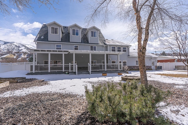 1045 Fox Farm Rd, Logan, UT 84321 - snow covered back of property with a porch and fence