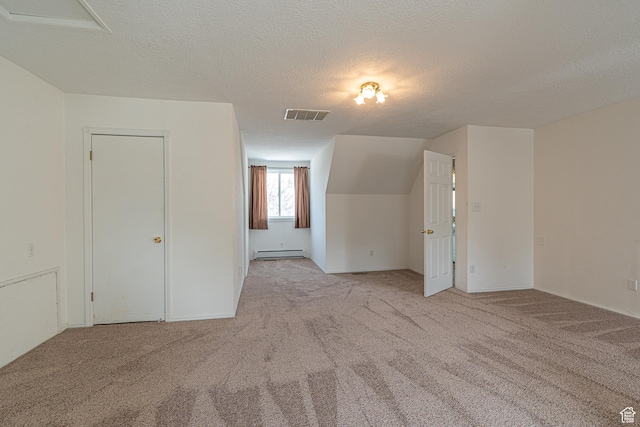 1045 Fox Farm Rd, Logan, UT 84321 - additional living space featuring carpet, visible vents, a baseboard heating unit, and a textured ceiling