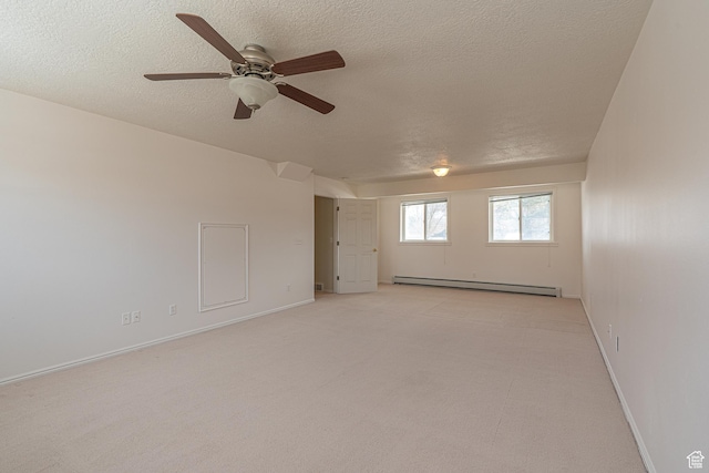 1045 Fox Farm Rd, Logan, UT 84321 - empty room featuring baseboards, light colored carpet, a textured ceiling, and baseboard heating