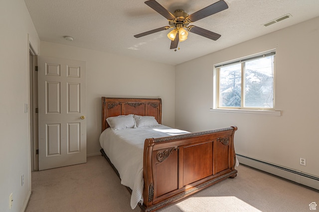 1045 Fox Farm Rd, Logan, UT 84321 - bedroom with a textured ceiling, a baseboard radiator, light carpet, visible vents, and a ceiling fan