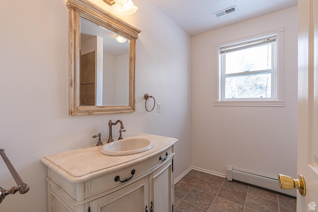 1045 Fox Farm Rd, Logan, UT 84321 - bathroom with baseboards, visible vents, vanity, and baseboard heating