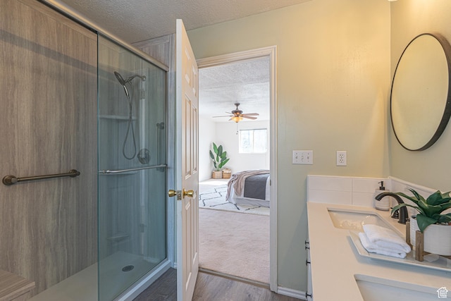 1045 Fox Farm Rd, Logan, UT 84321 - full bathroom with a shower with door, ceiling fan, wood finished floors, ensuite bathroom, and a textured ceiling