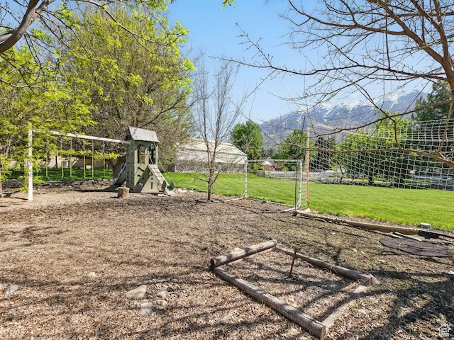 view of grassy yard featuring a playground