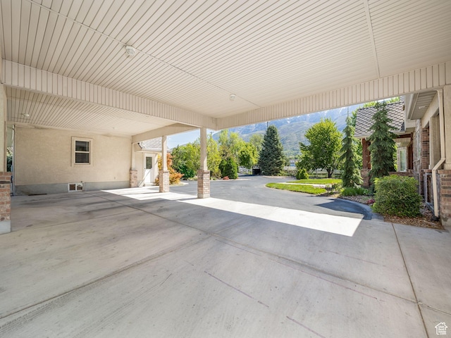 view of patio / terrace featuring a carport and a mountain view