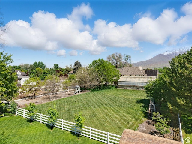 view of yard featuring an exterior structure, a mountain view, and an outdoor structure