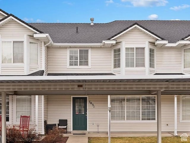 view of property featuring a shingled roof