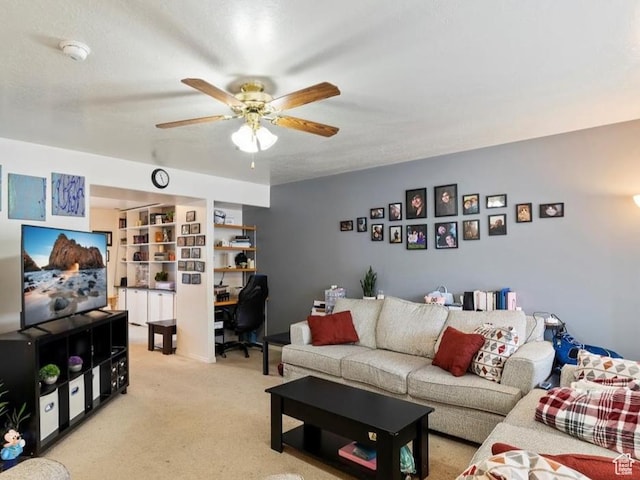 living room with a ceiling fan and light carpet