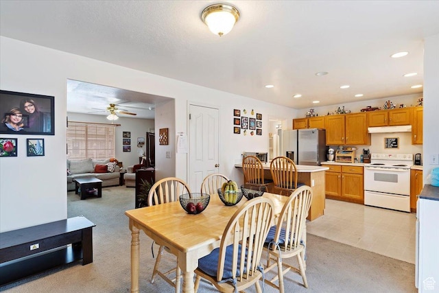 dining space with ceiling fan, recessed lighting, and light colored carpet