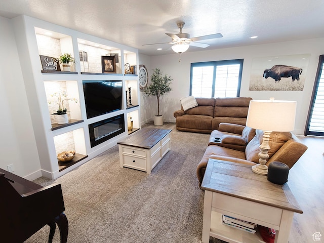 926 N 165 W, Nephi, UT 84648 - living room with recessed lighting, a glass covered fireplace, light carpet, ceiling fan, and baseboards