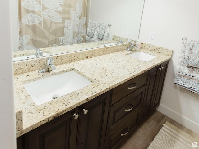 926 N 165 W, Nephi, UT 84648 - full bathroom with double vanity, wood finished floors, a sink, and baseboards
