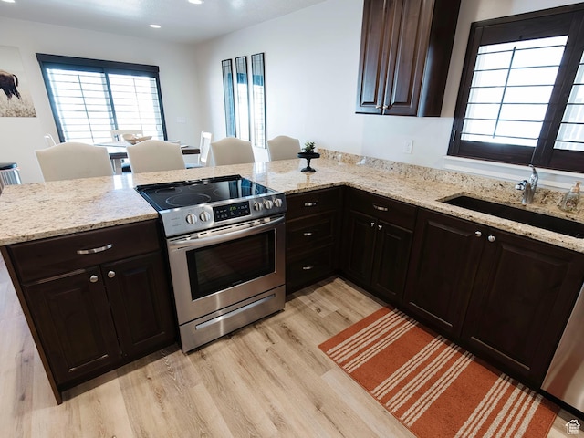 926 N 165 W, Nephi, UT 84648 - kitchen featuring a peninsula, light stone countertops, stainless steel electric stove, light wood-style floors, and a sink