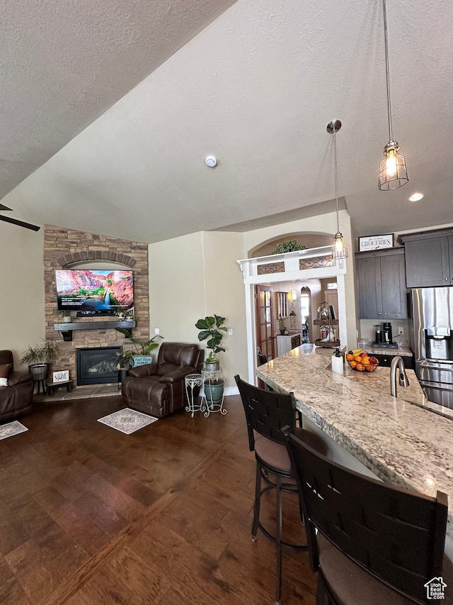 338 S 1230 E, Tooele, UT 84074 - kitchen featuring open floor plan, dark wood finished floors, light stone countertops, and stainless steel refrigerator with ice dispenser