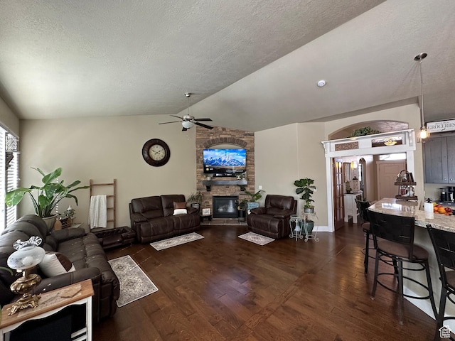 338 S 1230 E, Tooele, UT 84074 - living area featuring a fireplace, dark wood finished floors, a textured ceiling, a ceiling fan, and lofted ceiling
