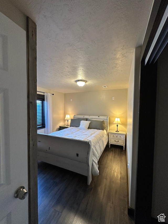 338 S 1230 E, Tooele, UT 84074 - bedroom featuring a textured ceiling and dark wood finished floors