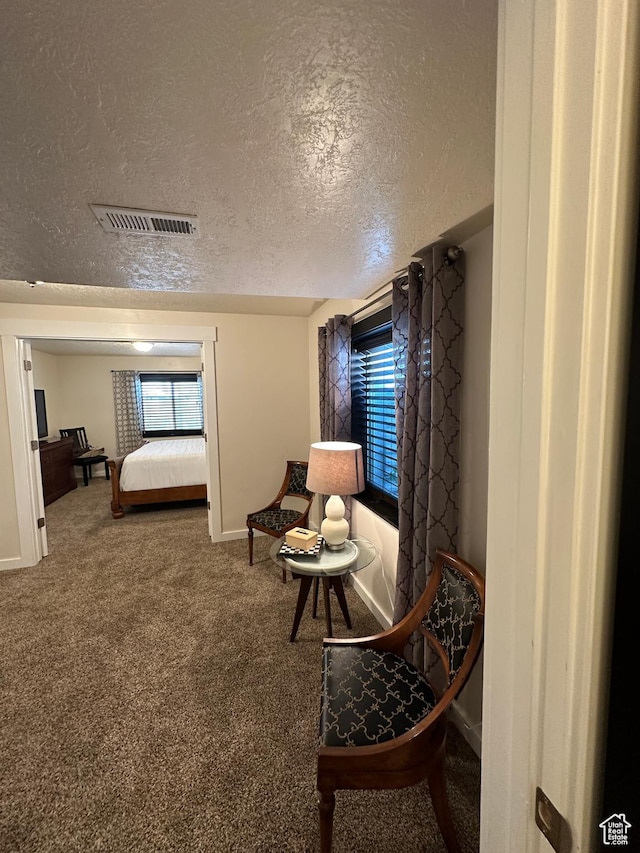 338 S 1230 E, Tooele, UT 84074 - sitting room featuring visible vents, baseboards, a textured ceiling, and carpet floors