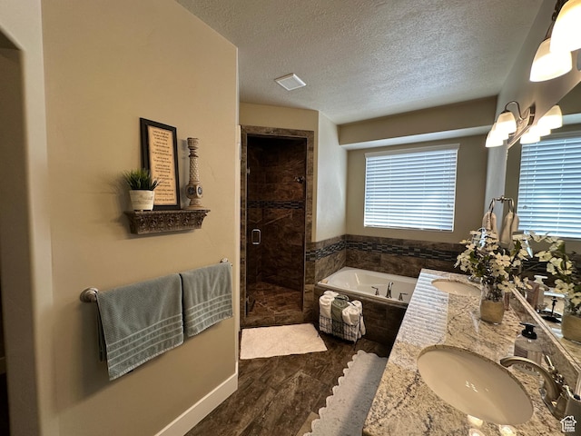 338 S 1230 E, Tooele, UT 84074 - full bath featuring a garden tub, a textured ceiling, a sink, a stall shower, and double vanity