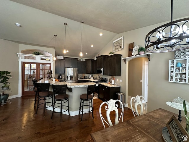 338 S 1230 E, Tooele, UT 84074 - kitchen with a breakfast bar, dark wood finished floors, lofted ceiling, and stainless steel appliances