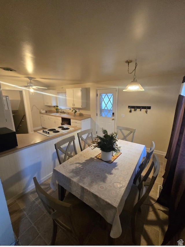 777 Simoron Dr, Ogden, UT 84404 - dining room featuring dark tile patterned floors, a ceiling fan, visible vents, and baseboards