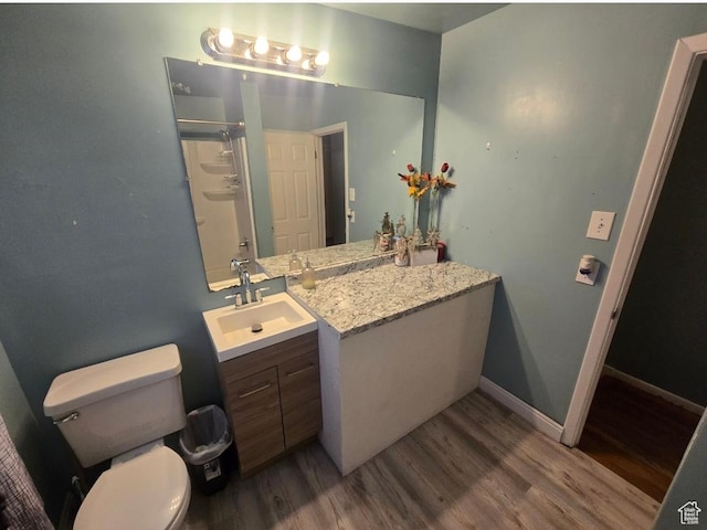 777 Simoron Dr, Ogden, UT 84404 - full bath with a shower with shower door, toilet, wood finished floors, baseboards, and vanity